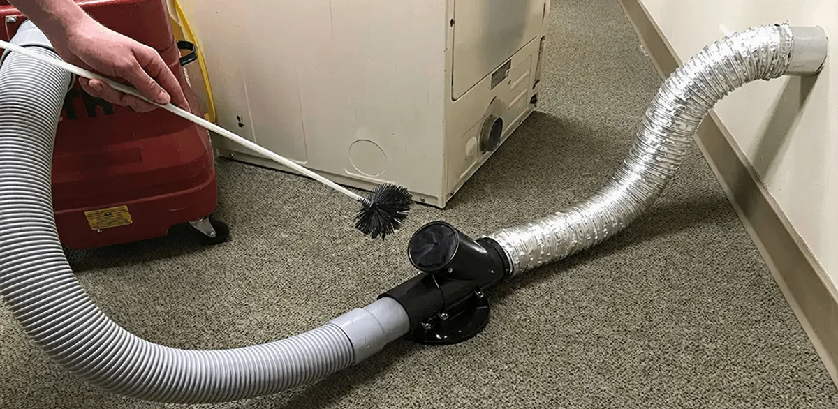 Dryer vent cleaning service removing lint from a dryer duct connection in San Diego, CA