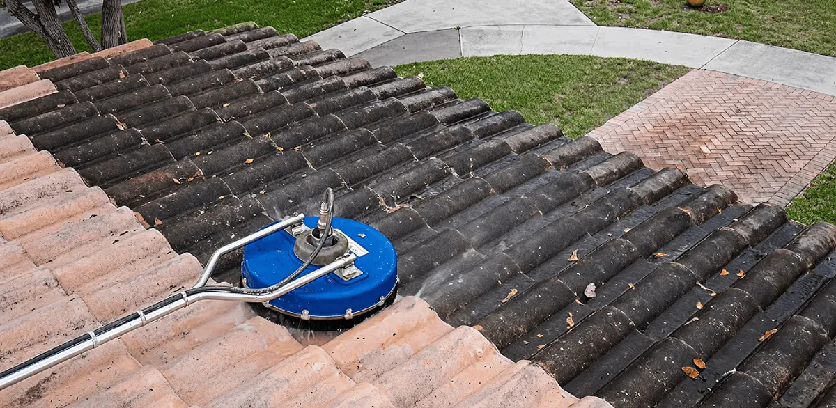 Roof pressure cleaning removing debris and buildup from roof tiles in San Diego, CA