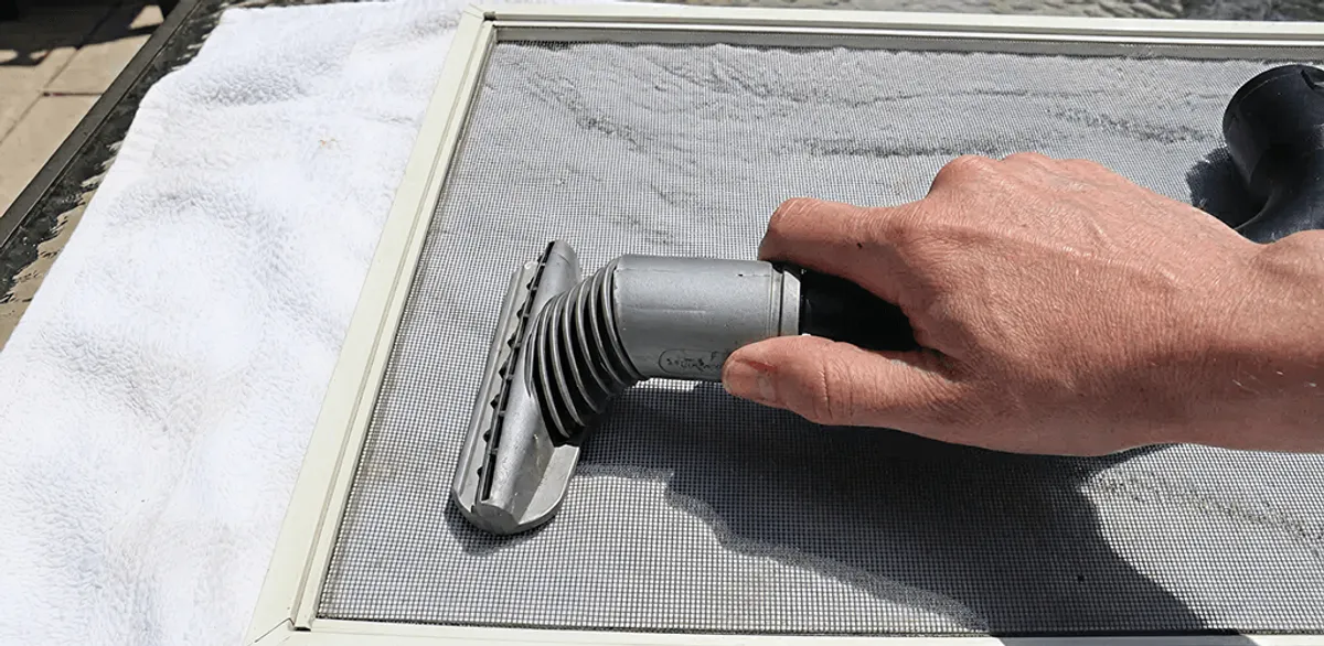Window screen repair cleaning and fixing a damaged screen mesh in San Diego, CA